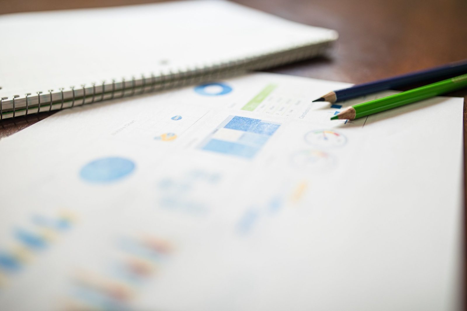 Data charts and colored pencils on a desk
