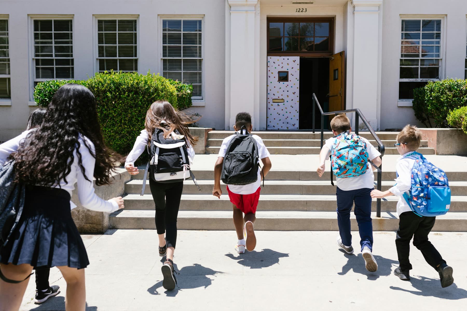 Students walking up the steps into school
